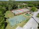 Aerial view of community featuring tennis and basketball courts, playground, and lush surroundings at 3885 Timber Ridge Ct, Palm Harbor, FL 34685