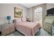 Serene bedroom featuring soft colors, a cozy bed, and ample natural light from the arched window at 3885 Timber Ridge Ct, Palm Harbor, FL 34685