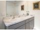 Bathroom featuring a double sink vanity, framed mirrors, and neutral wall art at 4114 Dovetail Ln, Palmetto, FL 34221