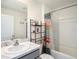 Bathroom with a modern vanity, sleek faucet, and shower with decorative curtain at 4114 Dovetail Ln, Palmetto, FL 34221