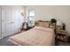 Bedroom featuring a bed with a floral patterned bedspread, adjacent window, and closet at 4114 Dovetail Ln, Palmetto, FL 34221