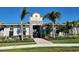 Exterior shot of Silverstone's clubhouse entrance with stone accents, landscaping, and palm trees at 4114 Dovetail Ln, Palmetto, FL 34221