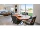 Cozy dining area featuring a wooden table, upholstered chairs, and natural light from sliding glass doors to the backyard at 4114 Dovetail Ln, Palmetto, FL 34221