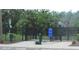 A fenced dog park features waste bag dispensers, signage, and ample space for pets to roam and play within the community at 4114 Dovetail Ln, Palmetto, FL 34221