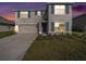Charming two-story home with a well-maintained lawn, attached garage, and inviting curb appeal at 4114 Dovetail Ln, Palmetto, FL 34221