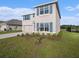 Attractive two-story home boasts tidy landscaping, double-car garage, and contrasting blue shutters and front door at 4114 Dovetail Ln, Palmetto, FL 34221