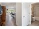Hallway view showing access to an open floor plan, dining area, and a full bathroom at 4114 Dovetail Ln, Palmetto, FL 34221