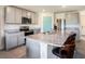Stylish kitchen equipped with stainless steel appliances, granite countertops, breakfast bar, and ample cabinet space at 4114 Dovetail Ln, Palmetto, FL 34221