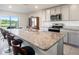 Modern kitchen boasts granite countertops, stainless steel appliances, breakfast bar seating and an adjacent view to the backyard at 4114 Dovetail Ln, Palmetto, FL 34221