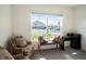 Cozy living room with ample natural light from a large window, plus comfortable seating and stylish furnishings at 4114 Dovetail Ln, Palmetto, FL 34221