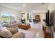 Spacious living room showcases an open layout, with views of the backyard and adjacent dining and kitchen spaces at 4114 Dovetail Ln, Palmetto, FL 34221