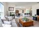Open-concept living area features a modern kitchen, tiled floors, and comfortable seating for the whole Gathering at 4114 Dovetail Ln, Palmetto, FL 34221