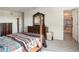 Spacious bedroom featuring a four-poster bed, dresser, and bathroom entrance at 4114 Dovetail Ln, Palmetto, FL 34221