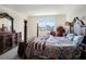 Spacious main bedroom with a four-poster bed, dresser, and plenty of natural light from a window at 4114 Dovetail Ln, Palmetto, FL 34221