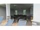 A large covered outdoor seating area features tables, chairs, and fans for residents to enjoy by the community pool at 4114 Dovetail Ln, Palmetto, FL 34221
