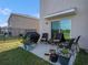 Cozy patio with comfortable seating, a grill, and a view of the landscaped backyard at 4114 Dovetail Ln, Palmetto, FL 34221