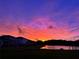 Beautiful sunset view overlooking the water near the residential homes, under a colorful sky at 4114 Dovetail Ln, Palmetto, FL 34221