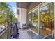 Balcony with comfortable seating, potted plants, and a view into bedroom through sliding glass door at 475 2Nd N St # 201, St Petersburg, FL 33701