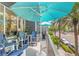 Balcony with blue Adirondack chairs, a table with flowers, and street views at 475 2Nd N St # 201, St Petersburg, FL 33701