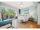 This bedroom includes light blue walls, a large bed, and a terrace with an outdoor seating area at 475 2Nd N St # 201, St Petersburg, FL 33701