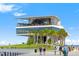 Exterior view of a modern building with palm trees, lawns, and blue skies at 475 2Nd N St # 201, St Petersburg, FL 33701
