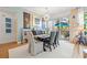 Stylish dining room featuring a long table, elegant chairs, and sliding glass doors to the outside patio at 475 2Nd N St # 201, St Petersburg, FL 33701