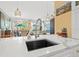 Open concept condo kitchen with island sink, stylish lighting, and inviting living space at 475 2Nd N St # 201, St Petersburg, FL 33701