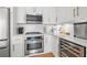 Gourmet condo kitchen featuring modern appliances, wine fridge, and stylish white cabinetry at 475 2Nd N St # 201, St Petersburg, FL 33701