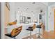 Modern condo kitchen with seating at the island, stainless steel appliances and stylish pendant lights at 475 2Nd N St # 201, St Petersburg, FL 33701