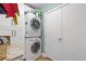 Convenient laundry room with a stacked washer and dryer, storage cabinets, and granite countertops at 475 2Nd N St # 201, St Petersburg, FL 33701