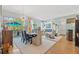 Open-concept living and dining area with a modern fireplace and floor-to-ceiling windows leading to a balcony at 475 2Nd N St # 201, St Petersburg, FL 33701