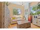Living room featuring a cream sofa, hardwood floors, and multiple windows at 475 2Nd N St # 201, St Petersburg, FL 33701