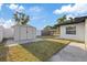 Spacious backyard with a storage shed, partial fencing, and a well-maintained lawn at 504 Driftwood E Dr, Palm Harbor, FL 34683