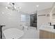 Bright bathroom featuring a modern tub, glass-enclosed shower, and contemporary fixtures at 504 Driftwood E Dr, Palm Harbor, FL 34683