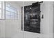 Modern bathroom with large glass shower, black and white tile at 504 Driftwood E Dr, Palm Harbor, FL 34683
