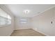 Bedroom with white trim, wood-look floors, and natural light at 504 Driftwood E Dr, Palm Harbor, FL 34683