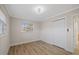 Bright bedroom with white trim, wood-look floors, and natural light at 504 Driftwood E Dr, Palm Harbor, FL 34683