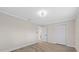 Bedroom with wood-look floors, white trim, and ample space at 504 Driftwood E Dr, Palm Harbor, FL 34683