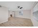 Spacious bedroom with laminate flooring, ceiling fan, and neutral wall paint at 504 Driftwood E Dr, Palm Harbor, FL 34683
