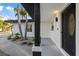Close up of a home featuring a well-manicured tropical landscaping and an inviting front door at 504 Driftwood E Dr, Palm Harbor, FL 34683