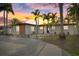 Charming single-story home featuring a well-manicured yard with lush tropical landscaping and an inviting entrance at 504 Driftwood E Dr, Palm Harbor, FL 34683