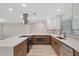 The beautifully appointed kitchen features sleek countertops, stainless steel appliances, and stylish wood cabinetry at 504 Driftwood E Dr, Palm Harbor, FL 34683