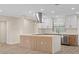 The kitchen features a large center island, waterfall countertops, a modern range hood, and ample cabinet space at 504 Driftwood E Dr, Palm Harbor, FL 34683