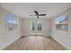 Bright room with laminate flooring, ceiling fan, and neutral wall paint at 504 Driftwood E Dr, Palm Harbor, FL 34683