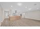 Open-concept living space with modern kitchen, center island, and ample room for entertaining and Gathering gatherings at 504 Driftwood E Dr, Palm Harbor, FL 34683