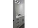 Bathroom vanity featuring white cabinets, quartz countertop, and black hardware at 5730 66Th Ln N, St Petersburg, FL 33709