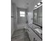 Contemporary bathroom with marble-look shower, double sink vanity, and modern fixtures at 5730 66Th Ln N, St Petersburg, FL 33709