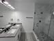 Contemporary bathroom with double vanity, glass shower, and modern gray and white finishes at 5730 66Th Ln N, St Petersburg, FL 33709