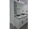Bright bathroom featuring a dual sink vanity with modern lighting and sleek fixtures creating a spa-like atmosphere at 5730 66Th Ln N, St Petersburg, FL 33709