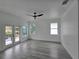 This large bedroom features wood-look flooring, a ceiling fan, and a balcony at 5730 66Th Ln N, St Petersburg, FL 33709